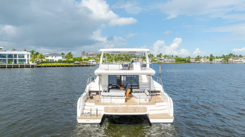 Slide: The Image of 2024 Leopard 53 Powercat yacht on a serene waterfront. - 14