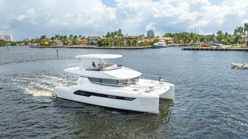 Slide: The Image of 2024 Leopard 53 Powercat cruising on a scenic waterway. - 2