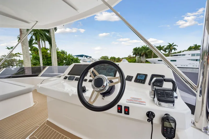 Slide: The Image of 2024 Leopard 53 Powercat helm with modern controls and tropical backdrop. - 27