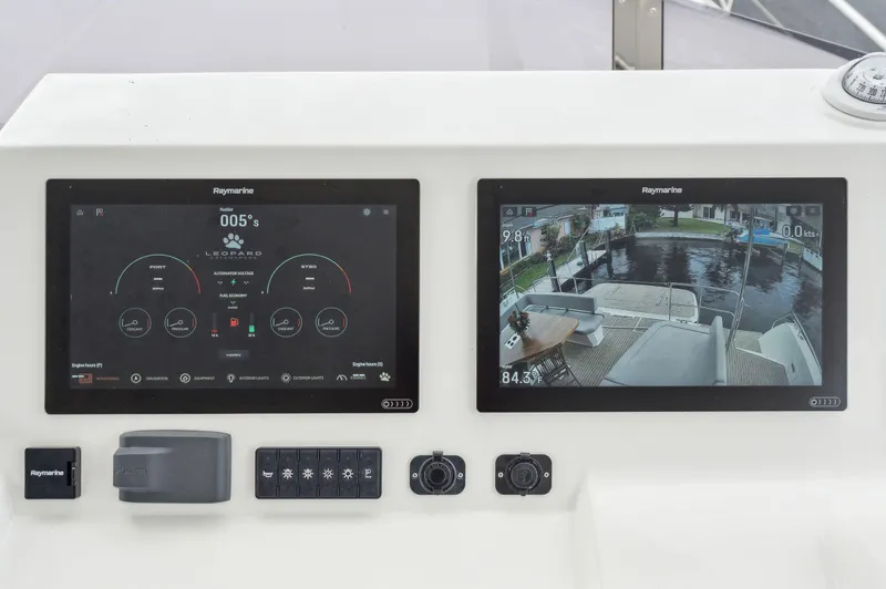 Slide: The Image of Leopard 53 Powercat 2024 dashboard with dual Raymarine displays and controls. - 28