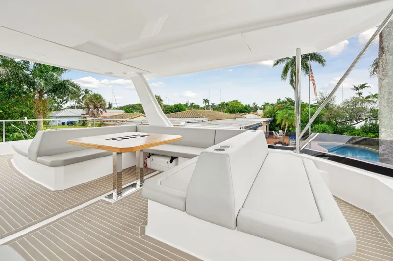 Slide: The Image of Luxurious 2024 Leopard 53 Powercat yacht with spacious outdoor seating and table. - 30