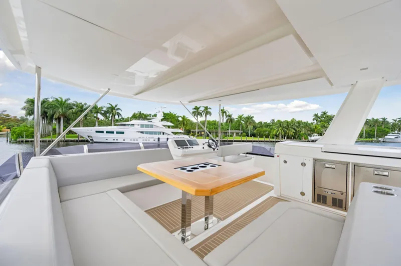 Slide: The Image of 2024 Leopard 53 Powercat yacht with spacious outdoor seating and dining area. - 32