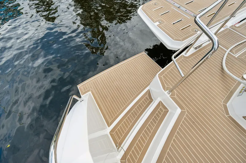 Slide: The Image of 2024 Leopard 53 Powercat swim platform with teak decking on calm water. - 40