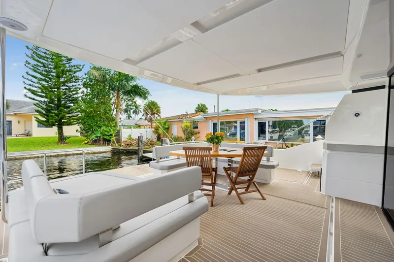 Slide: The Image of 2024 Leopard 53 Powercat yacht deck with seating and dining area. - 47