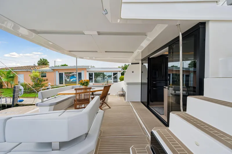 Slide: The Image of 2024 Leopard 53 Powercat yacht deck with modern seating and dining area. - 48