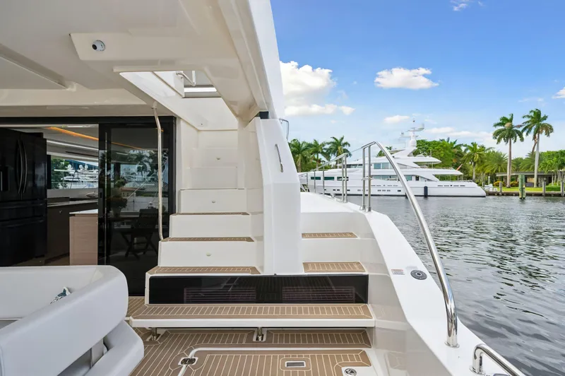 Slide: The Image of 2024 Leopard 53 Powercat yacht docked by palm trees and water. - 49