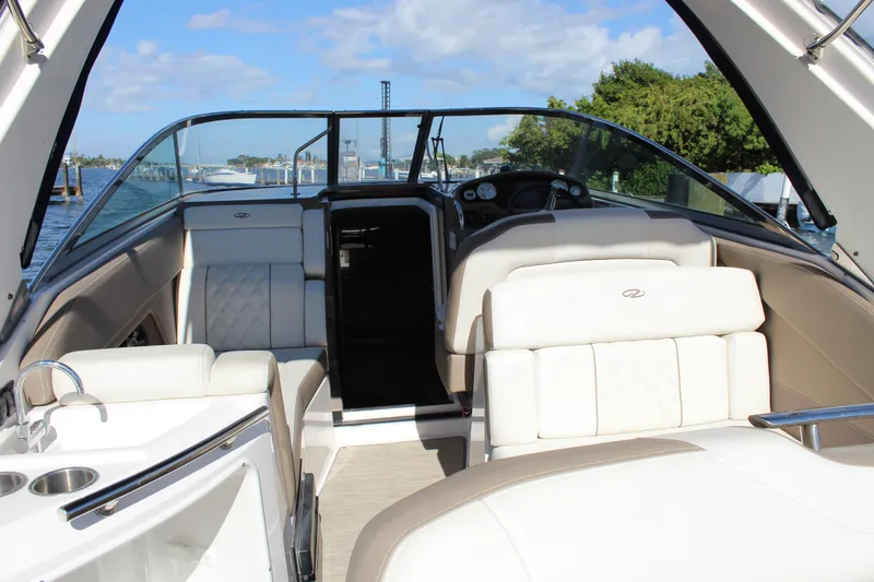 Slide: The Image of 2018 Regal 28 Express boat interior with luxurious seating and scenic waterfront view. - 13