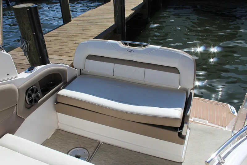 Slide: The Image of 2018 Regal 28 Express boat interior with cushioned seating by the dock. - 14