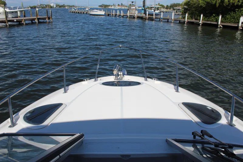 Slide: The Image of 2018 Regal 28 Express boat on calm water, docked in a marina. - 24