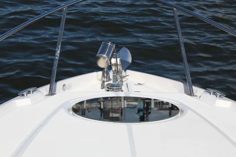 Slide: The Image of Bow of 2018 Regal 28 Express boat with stainless steel railings on water. - 26