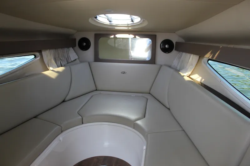 Slide: The Image of Interior of 2018 Regal 28 Express boat with beige seating and circular skylight. - 29