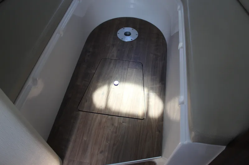 Slide: The Image of 2018 Regal 28 Express boat interior with wood flooring and storage compartment. - 30