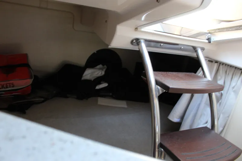 Slide: The Image of Interior cabin of 2018 Regal 28 Express boat with wooden steps and storage area. - 38