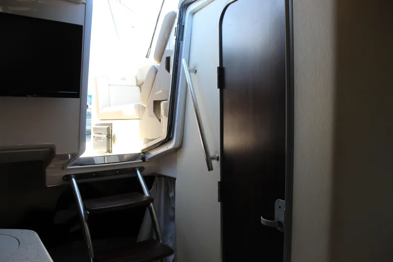 Slide: The Image of Interior view of 2018 Regal 28 Express boat cabin with stairs and door. - 39