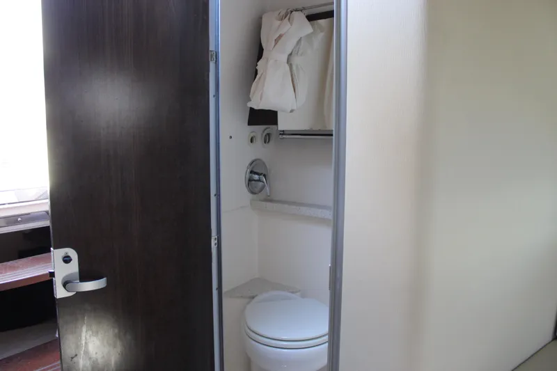 Slide: The Image of 2018 Regal 28 Express boat interior bathroom with toilet and storage. - 40