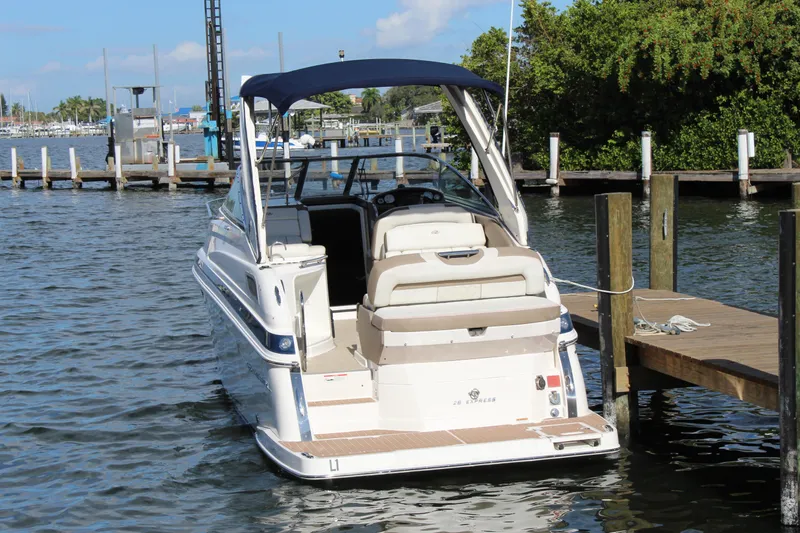 Slide: The Image of 2018 Regal 28 Express boat docked at a marina, featuring a sleek design and spacious seating. - 5