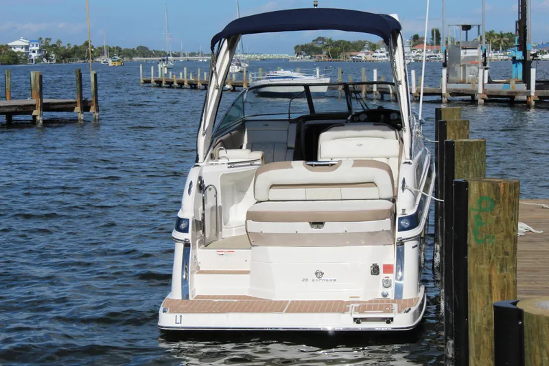 Slide: The Image of 2018 Regal 28 Express boat docked at a marina, rear view. - 6