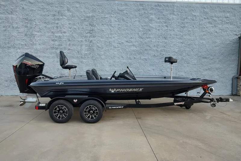 Slide: The Image of 2026 Phoenix 919 ZXL boat with powerful outboard motor at sunset. - 4