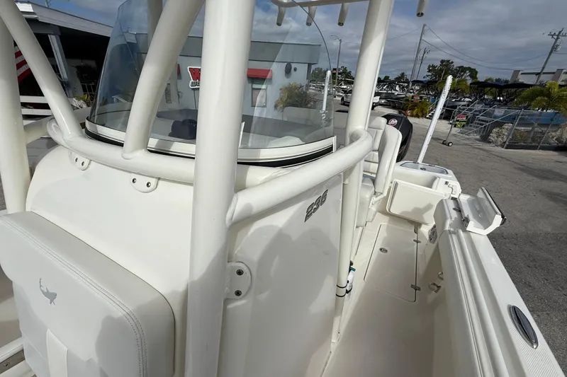 Slide: The Image of 2022 Mako 234 Center Console boat, white interior, docked outdoors. - 15