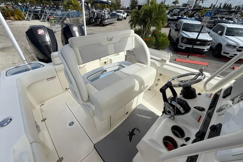 Slide: The Image of 2022 Mako 234 Center Console boat interior with helm, seating, and dual outboard motors. - 17