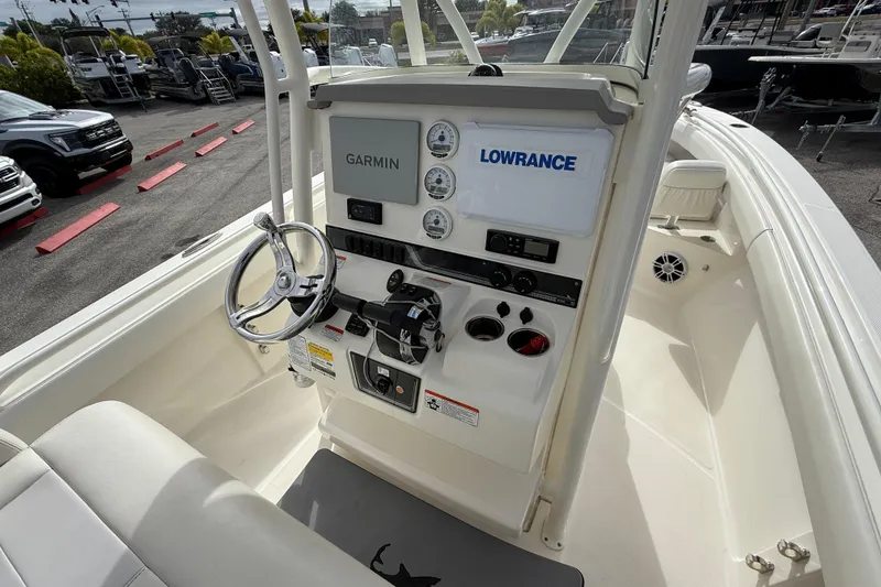 Slide: The Image of 2022 Mako 234 Center Console boat dashboard with Garmin and Lowrance equipment. - 19
