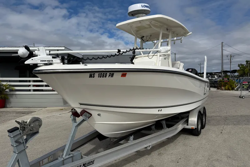 Slide: The Image of 2022 Mako 234 Center Console boat on trailer, featuring Minn Kota trolling motor. - 3