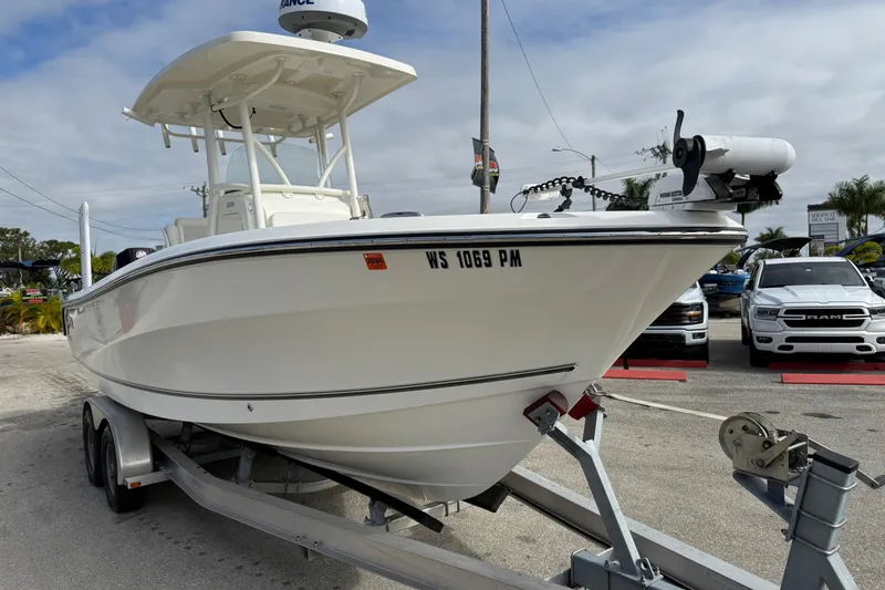Slide: The Image of 2022 Mako 234 Center Console boat on trailer, parked outdoors. - 5
