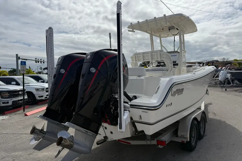 Slide: The Image of 2022 Mako 234 Center Console boat with dual engines, parked on a trailer. - 7
