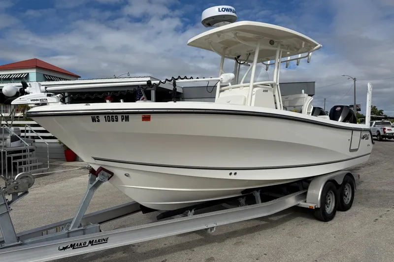 The Image of 2022 Mako 234 Center Console boat on trailer, displayed outdoors. - 1