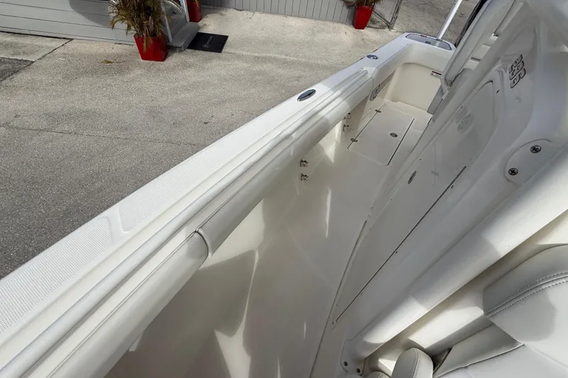 Slide: The Image of 2022 Mako 234 Center Console boat interior, showcasing sleek white design and spacious layout. - 16