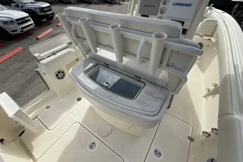 Slide: The Image of 2022 Mako 234 Center Console boat interior with rod holders and storage compartment. - 20
