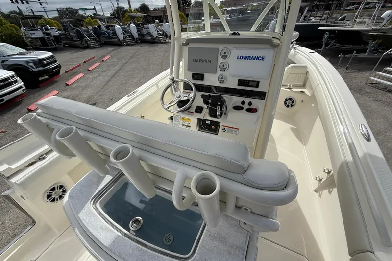 Slide: The Image of 2022 Mako 234 Center Console boat interior with steering wheel and control panel. - 21