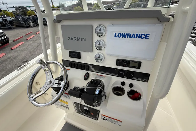 Slide: The Image of 2022 Mako 234 Center Console boat dashboard with Garmin and Lowrance systems. - 24