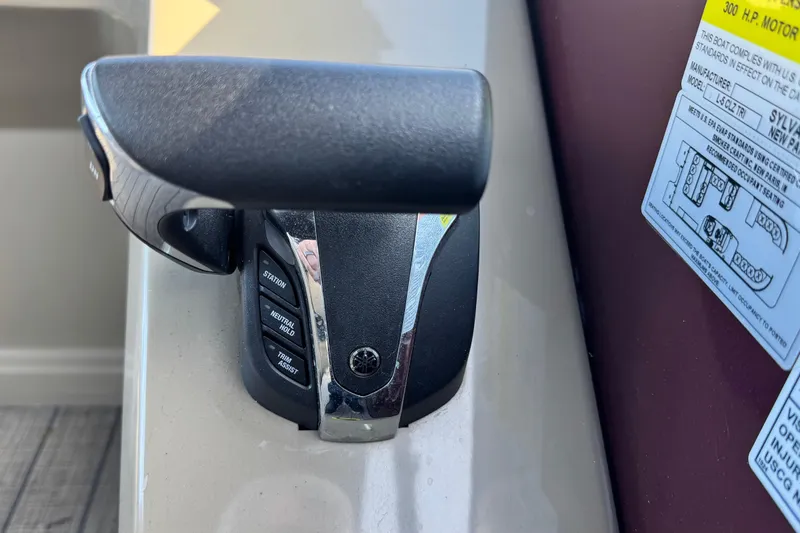 Slide: The Image of Close-up of 2023 Sylvan L5 CLZ boat throttle control with label and buttons. - 14