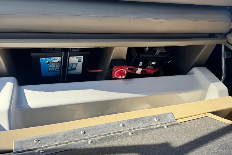 Slide: The Image of 2023 Sylvan L5 CLZ boat battery compartment with Marine Master battery and red switch. - 18