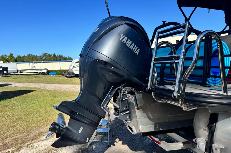 Slide: The Image of 2023 Sylvan L5 CLZ boat with Yamaha outboard motor in a sunny outdoor setting. - 20