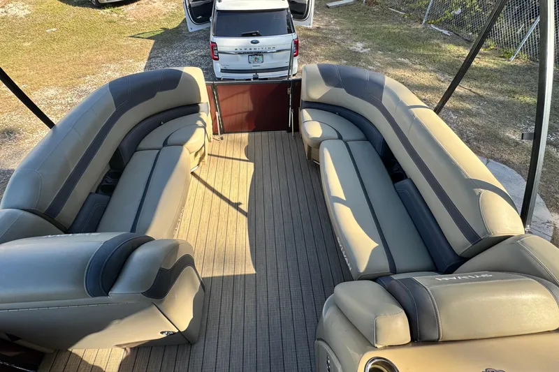 Slide: The Image of 2023 Sylvan L5 CLZ pontoon boat interior with luxurious seating and open rear view. - 3