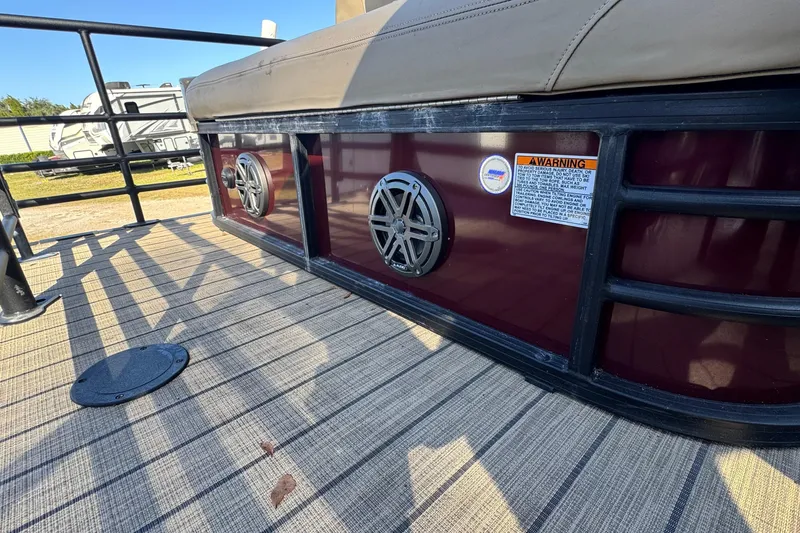 Slide: The Image of 2023 Sylvan L5 CLZ boat deck with speakers and warning label. - 5