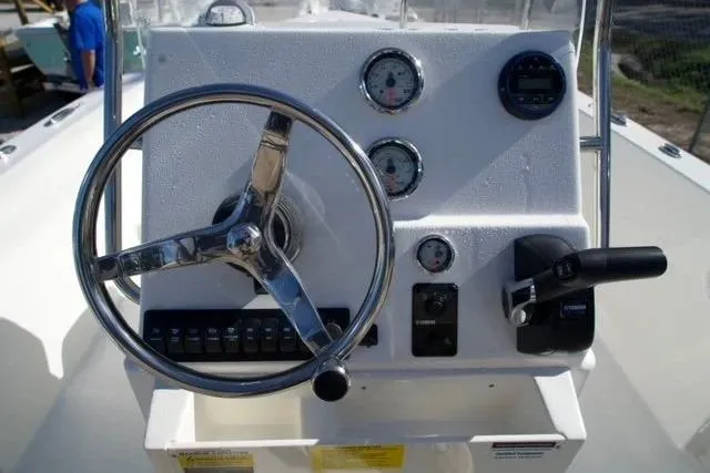 Slide: The Image of Steering console of 2026 Key West 179 FS boat with gauges and controls. - 2