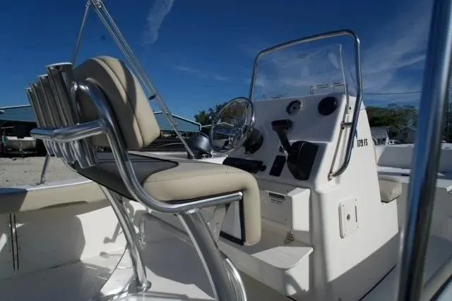 Slide: The Image of 2026 Key West 179 FS boat interior with steering console and seating. - 3