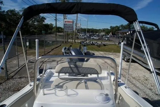 Slide: The Image of 2026 Key West 179 FS boat with canopy, parked outdoors near dealership. - 5