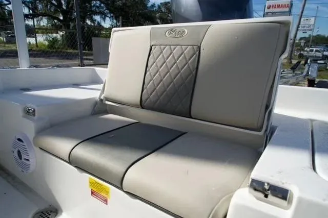 Slide: The Image of 2026 Key West 179 FS boat seat with quilted upholstery and outdoor setting. - 8