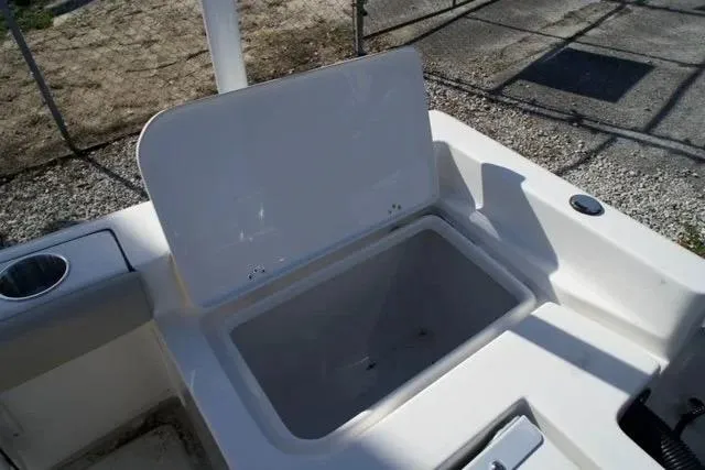 Slide: The Image of Open storage compartment on 2026 Key West 179 FS boat, featuring cup holder and clean design. - 9
