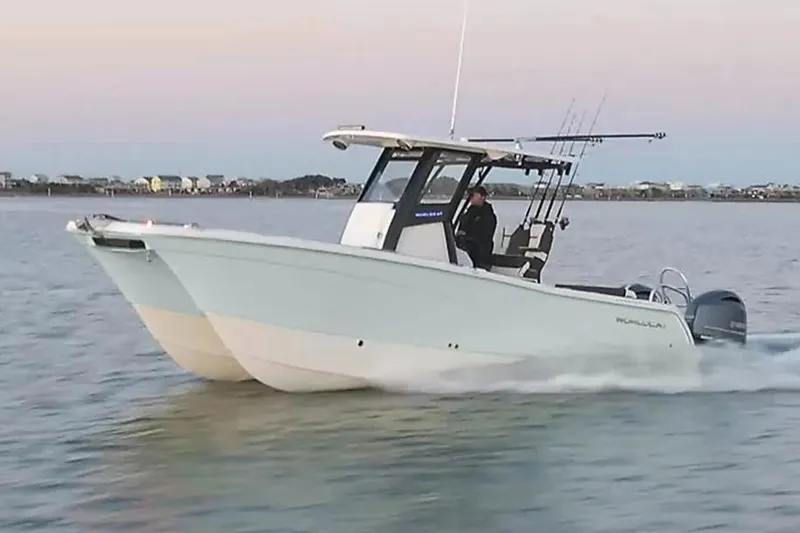 Slide: The Image of Manufacturer Provided Image: 2026 World Cat 265 CC-X boat cruising on calm water at sunset. - 3