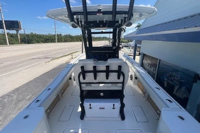 Slide: The Image of 2026 World Cat 265 CC-X boat interior with seating and console, docked outdoors. - 6