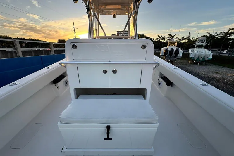 Slide: The Image of 2022 SeaVee 340Z boat interior with seating and storage, sunset view. - 10