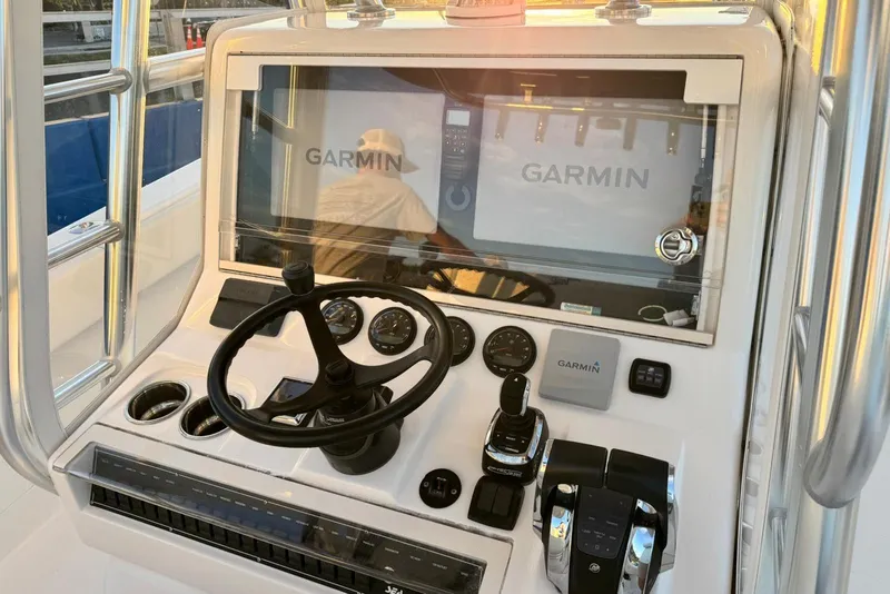 Slide: The Image of 2022 SeaVee 340Z boat dashboard with Garmin navigation system and steering wheel. - 14