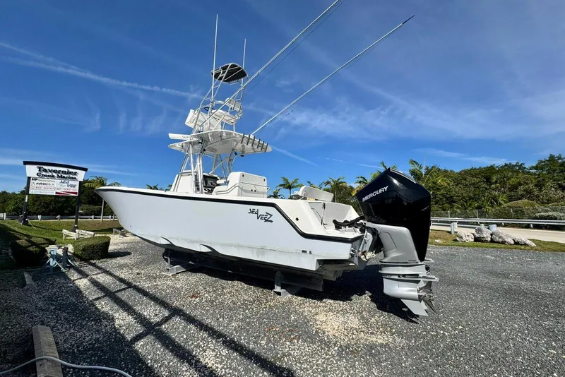 Slide: The Image of 2022 SeaVee 340Z boat with Mercury engine displayed at marina under clear blue sky. - 4
