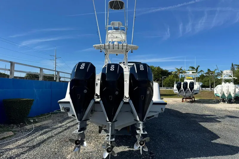 Slide: The Image of 2022 SeaVee 340Z boat with triple 300 horsepower engines, parked outdoors. - 5