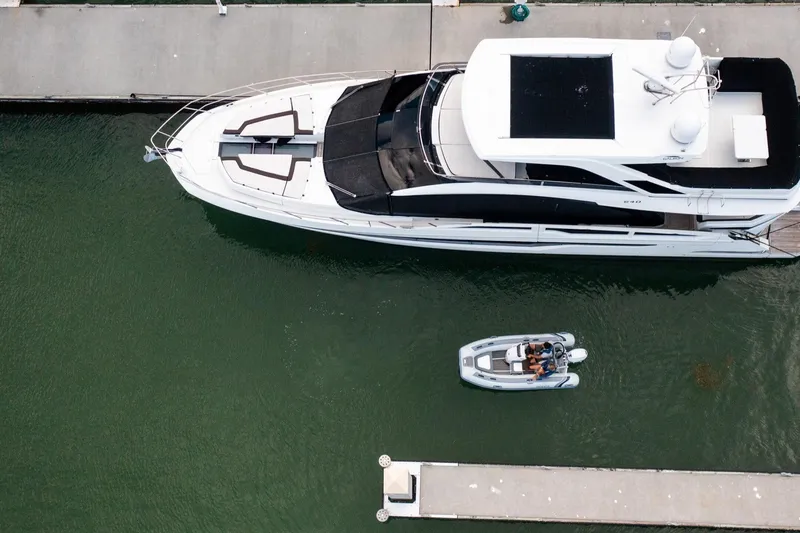 Slide: The Image of Aerial view of Highfield Classic 380 FCT beside a yacht, 2024 model. - 7